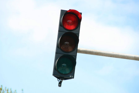 close-up photo of traffic lights, glowing red color to stop traffic