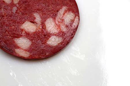 juicy piece of sausage close up on white backgroundの写真素材