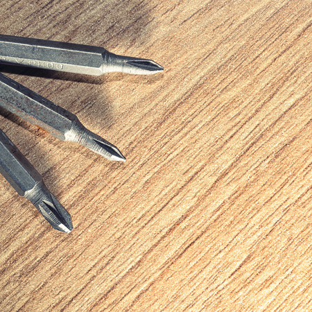 Screwdrive replaceable bits on a wooden background.Macro shotの写真素材