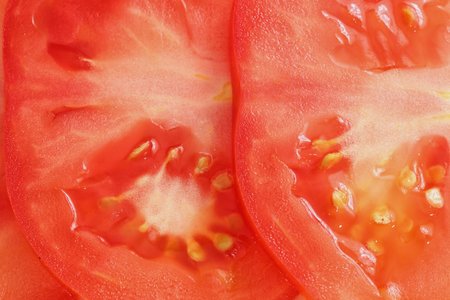 sliced tomato background.Extreme colse up.Fullscreenの写真素材