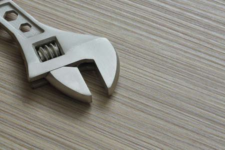 adjustable wrench closeup on wooden background. Extreme close upの写真素材