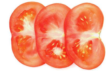 sliced tomato on white.Extreme colse up.Isolatedの写真素材