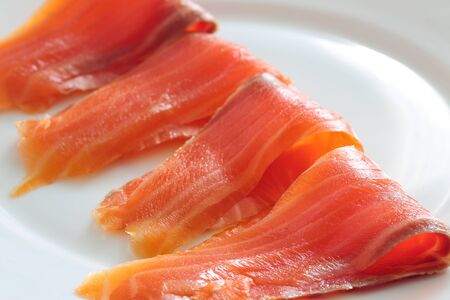 slices of salmon on a white plate. close upの写真素材