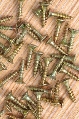 Screws on a wooden background close up.Macro shootの写真素材