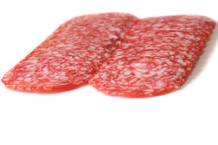 sliced salami on a white. Close up. Isolated on whiteの写真素材