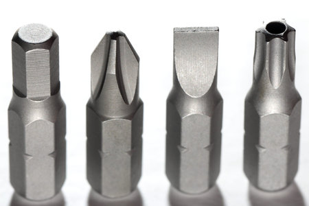 Set of screwdriver bits isolated on white. Mirror reflected