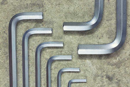 Hexagon or allen wrenches on concrete background