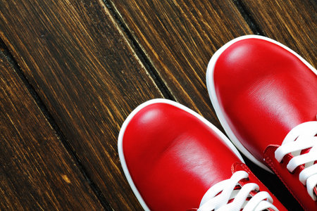 red shoes on wooden background. Brown backgroundの写真素材
