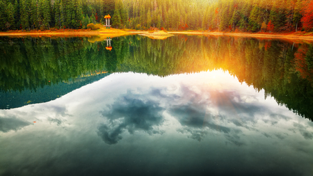 picturesque lake in the autumn forest. Mirror reflectionの写真素材