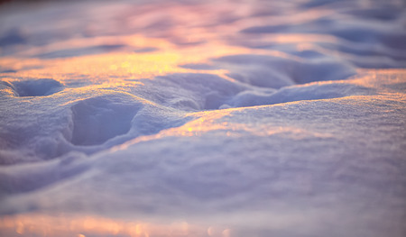 Natural winter background with snow drifts at sunset. Shallow depth of fieldの写真素材