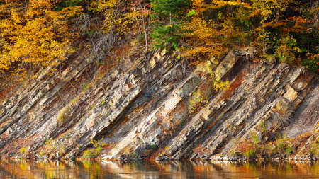 Rocky shore of lake in autumn time. colored wood