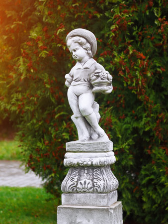 Vintage angle Boy statues in a park. Selective focusの写真素材