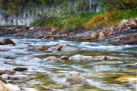 mountain river in autumn. Rocky shore. Multi-colour wood.の写真素材