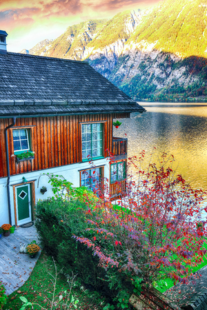 Wooden house on the coast of lake in Hallstatt village Austrian Alps. Location: resort village Hallstatt, Salzkammergut region, Austria, Alps. Europe.の写真素材