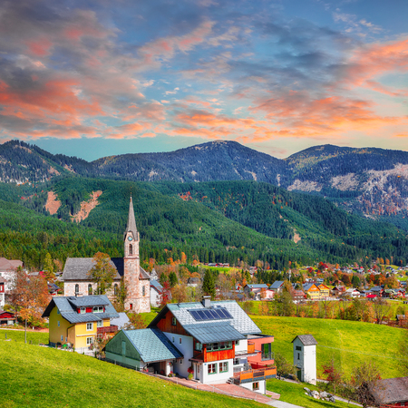 Alpine green fields and traditional wooden houses view of the Gosau village at autumn sunny day. Location: resort village Gosau Salzkammergut region, Gosau Valley in Upper Austria, Alps. Europe.の写真素材