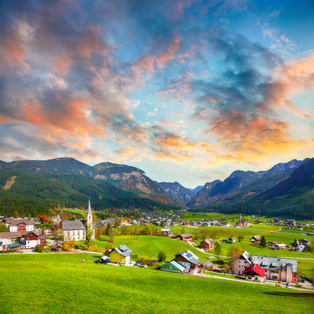 Alpine green fields and traditional wooden houses view of the Gosau village at autumn sunny day. Location: resort village Gosau Salzkammergut region, Gosau Valley in Upper Austria, Alps. Europe.の写真素材