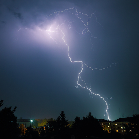 Lightning over the city. Powerfull flash at nightの写真素材