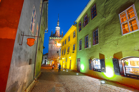 Splendid evening view of medieval city. Night view of historic town Sighisoara and Clock Tower built by Saxons, Transylvania, Romania, Europeの写真素材
