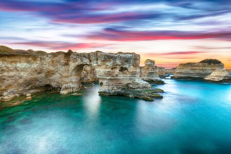 Dramatic seascape with cliffs, rocky arch at Torre Sant Andrea, Salento coast, Puglia region, Italyの写真素材