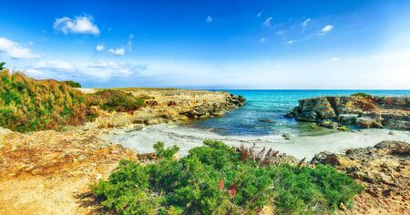 Picturesque seascape with white rocky cliffs, sea bay, islets and faraglioni near by Conca Specchiulla Beach, Salento Adriatic sea coast, Puglia, Italyの写真素材