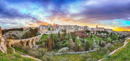 Gravina in Puglia ancient town, bridge and canyon at sunrise. Panoramic view of old city Gravina in Puglia, Apulia, Italy. Europeの写真素材