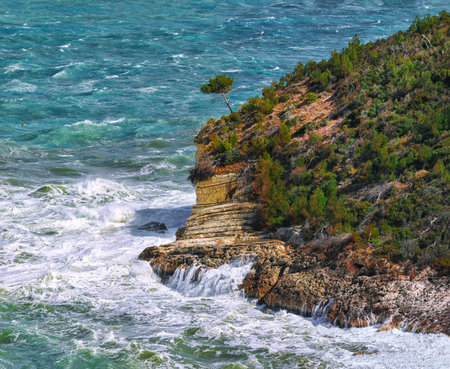 Above the cliffs at the coastline of Vieste. Summer rocky sea coast near Architello (Arch) of San Felice on the Gargano peninsula, Puglia, Italyの写真素材