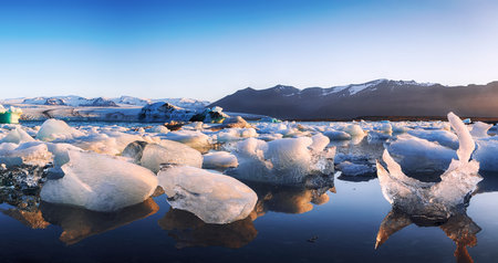 Beautifull landscape with floating icebergs in Jokulsarlon glacier lagoon at sunset. Location:...