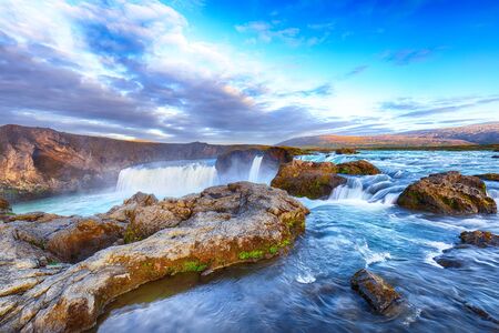 Breathtaking sunset landscape scene of powerful Godafoss waterfall. Dramatic sky over Godafoss. Location: Bardardalur valley, Skjalfandafljot river, Iceland, Europeの写真素材