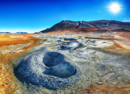 Boiling mudpots in the geothermal area Hverir and cracked ground around.  Location: geothermal area Hverir, Myvatn region, North part of Iceland, Europeの写真素材