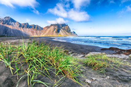 Fantastic sunny day and gorgeous black sand dunes on Stokksnes cape in Iceland. Location: Stokksnes cape, Vestrahorn , Iceland, Europe.の写真素材