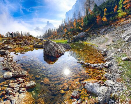Wonderfull autumn view of  Lake Federa in Dolomites . Fantastic autumn scene with colour sky, majestic rocky mount and colorful trees glowing sunlight in Dolomites. Location: Federa lake with Dolomites peak, Cortina DAmpezzo, South Tyrol, Dolomites, Italy, Europeの写真素材