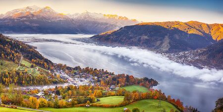 Spectacular autumn view of lake meadows trees and mountains in Sell Am See. Fantastic sunrise over lake. Location:  Zell am See, Salzburger Land, Austria, Europeの写真素材