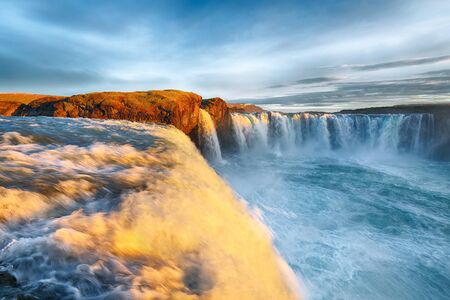 Fantastic sunrise scene of powerful Godafoss waterfall. Dramatic sky over Godafoss. Location: Bardardalur valley, Skjalfandafljot river, Iceland, Europeの写真素材