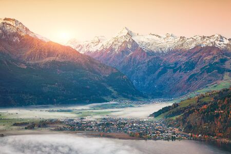 Spectacular autumn view of lake meadows trees and mountains in Sell Am See. Fantastic sunrise over lake. Location:  Zell am See, Salzburger Land, Austria, Europeの写真素材