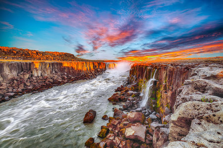Dramatic sunset view of fantastic waterfall and cascades of Selfoss waterfall. Location: Vatnajokull...