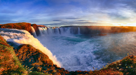 Fantastic sunrise scene of powerful Godafoss waterfall. Dramatic sky over Godafoss. Location:...