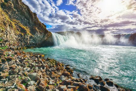 Fabulous scene of powerful Godafoss waterfall. Rocks at foreground. Location: Bardardalur valley, Skjalfandafljot river, Iceland, Europeの写真素材