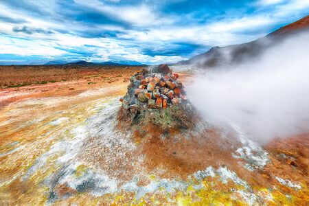 Steaming cone in Hverir geothermal area with boiling mudpools and steaming fumaroles in Iceland  Location: geothermal area Hverir, Myvatn region, North part of Iceland, Europeの写真素材