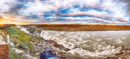 Dramatic sunset view  of the most powerful waterfall in Europe called Dettifoss. Location: Vatnajokull National Park,  river Jokulsa a Fjollum, Northeast Iceland, Europeの写真素材