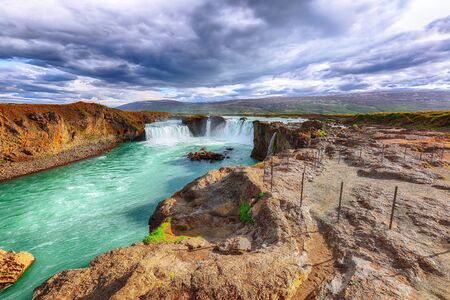 Incredible landscape scene of powerful Godafoss waterfall. Dramatic sky over Godafoss. Location: Bardardalur valley, Skjalfandafljot river, Iceland, Europeの写真素材