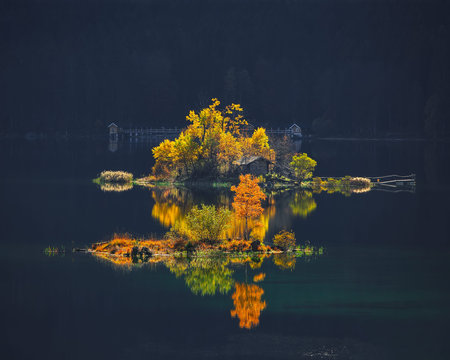 Charming autumn  landscape of islands with pine-trees in the middle of Eibsee lake.Location: Eibsee...