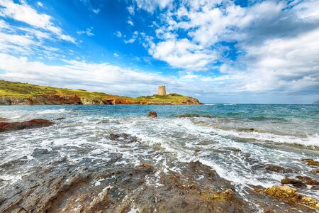 Gorgeous morning view  of Piscinni bay with turquoise sea and famous coastal tower of Piscinni.  Beautiful Mediterranean seascape.  Location:  Teulada, Sardinia, Italy Europeの写真素材