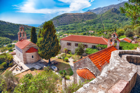 Stone church with bell tower at Gradiste monastery near Buljarica, Montenegro. Churchyard and abbey...