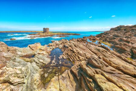 Stunning morning view of Famous La Pelosa beach and rocky shore near Torre della Pelosa.  Location:  Stintino, Province of Sassari, Italy, Europeの写真素材