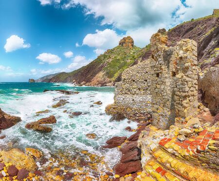 Fantastic spring view of ancient ruins of Laveria Lamarmora (Miniera di Nebida) and Nebida coast. Stunning Mediterranean seascape.  Location:  Nebida, Sardinia, Italy Europeの写真素材