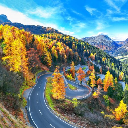 Stunning view of Maloja pass road at autumn time. Colorful autumn scene of Swiss Alps. Location: Maloya pass, Engadine region, Grisons canton, Switzerland, Europe.の写真素材