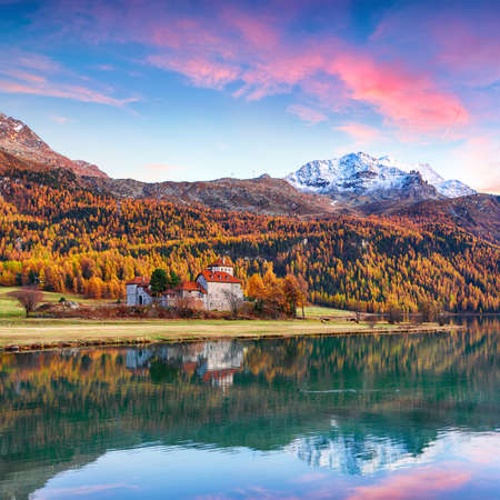 Astonishing autumn view of Crap da Sass castle on Silvaplana lake at sunset. Location: Silvaplana, Maloya district, Engadine region, Grisons canton, Switzerland, Europe.のeditorial素材