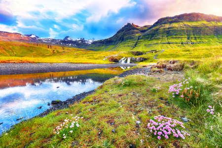 Dramatic view on Kirkjufellsfoss waterfall  near Kirkjufell mountain at sunset.  Location: Kirkjufellsfoss, Grundarfjordurn, Iceland, Europeの写真素材
