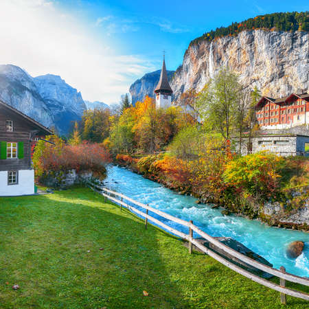 Gorgeous autumn landscape of  alpine village Lauterbrunnen with famous church and Staubbach waterfall. Location: Lauterbrunnen village, Berner Oberland, Switzerland, Europe.の写真素材