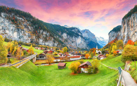 Astonishing autumn view of Lauterbrunnen valley with gorgeous Staubbach waterfall and Swiss Alps in the background.  Location: Lauterbrunnen village, Berner Oberland, Switzerland, Europe.の写真素材